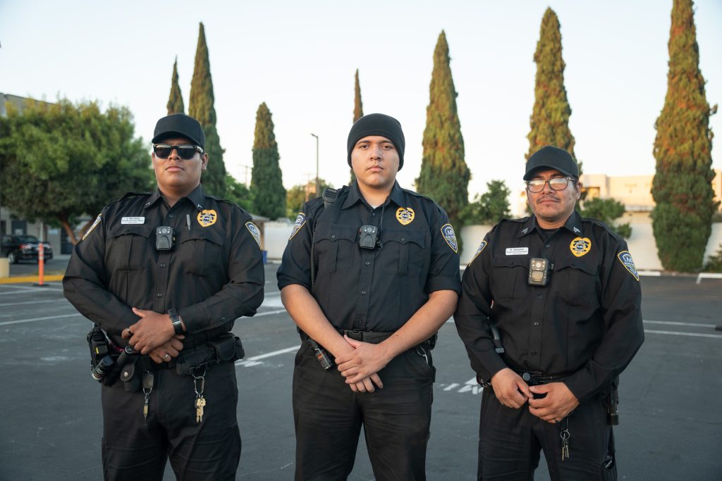 Three uniformed Main Patrol security officers with body cameras