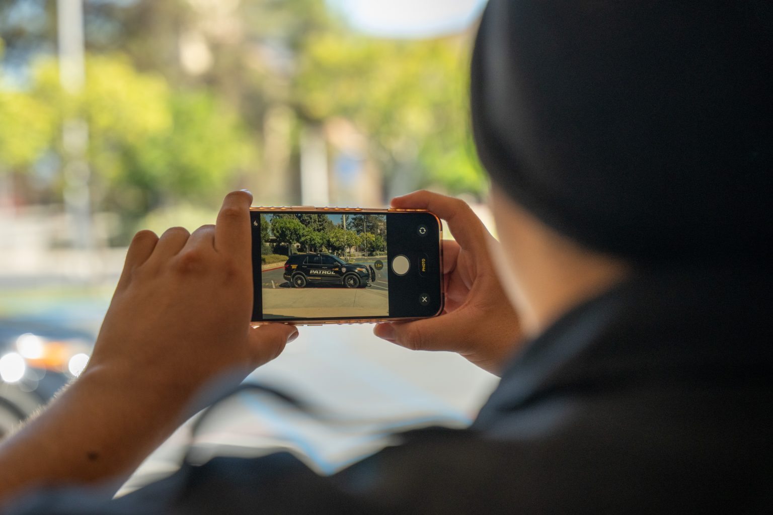 Main Patrol officer taking a timestamped photo of a patrol vehicle