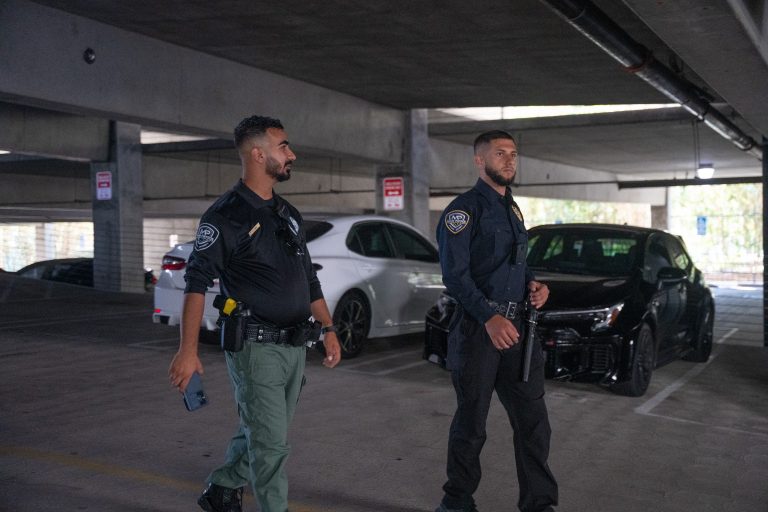 Two Main Patrol officers patrolling a parking garage