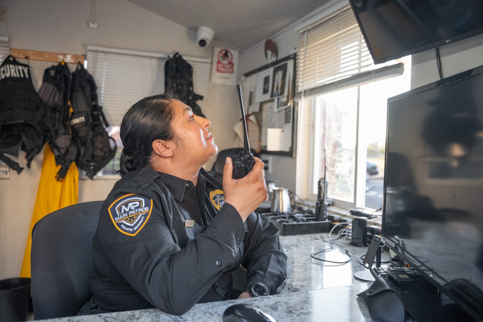 Main Patrol dispatcher using the radio in the security office