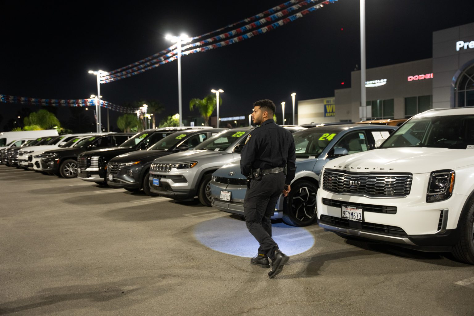 Main Patrol officer checking vehicles with a flashlight at night