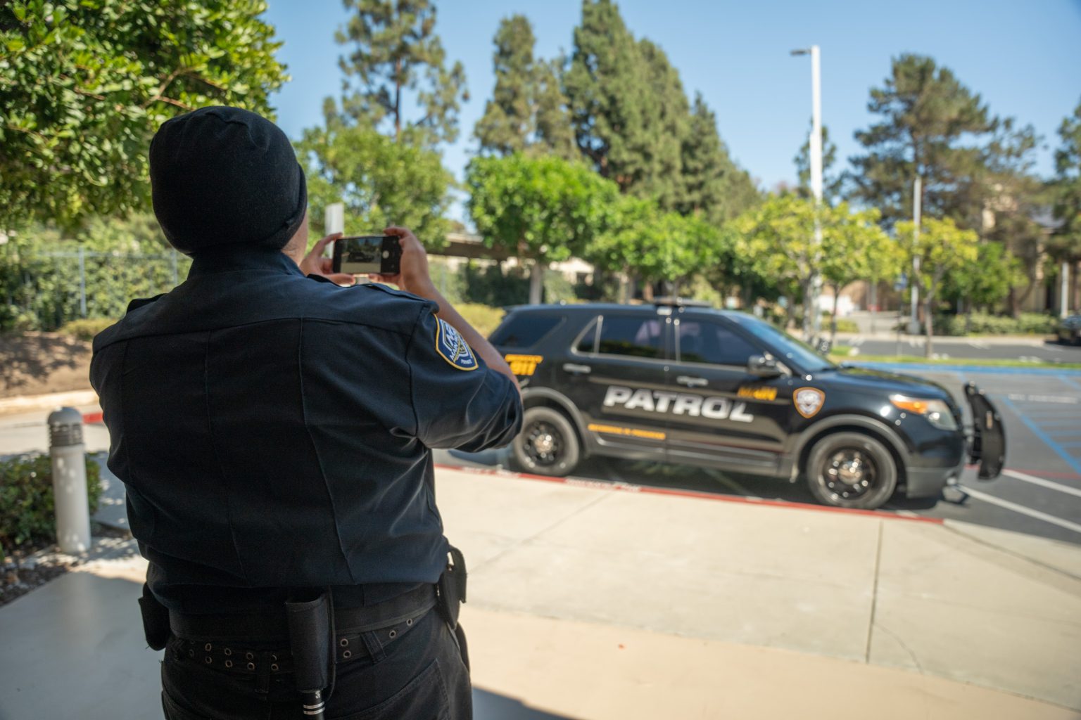 Main Patrol officer taking a timestamped photo of a patrol vehicle