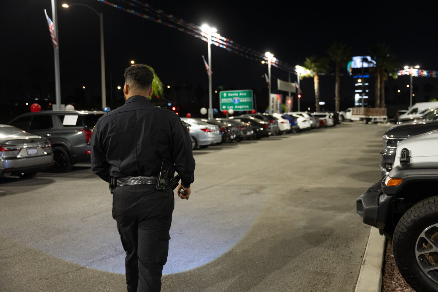 Main Patrol officer patrolling a dealership lot at night