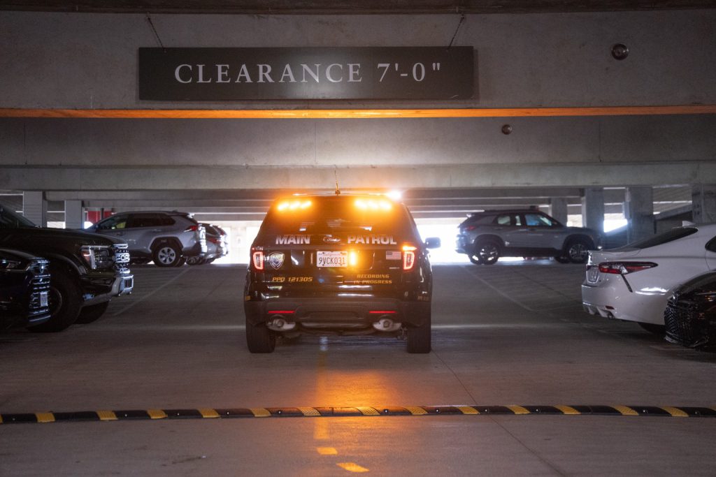 Main Patrol patrol SUV with amber lights inside a parking garage