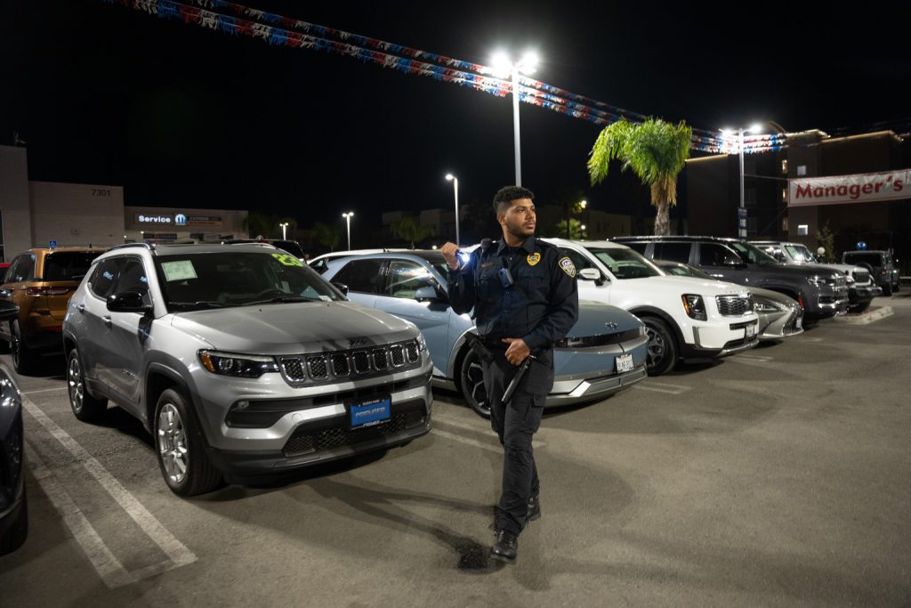Main Patrol officer patrolling a commercial vehicle lot at night