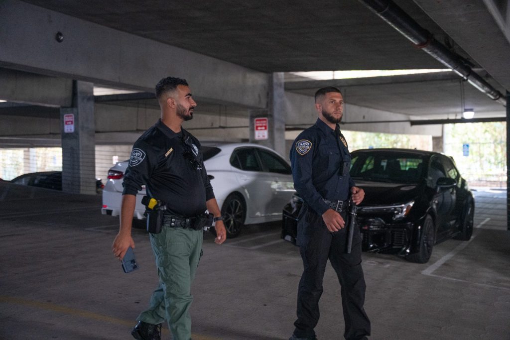 Two Main Patrol officers walking through a parking structure